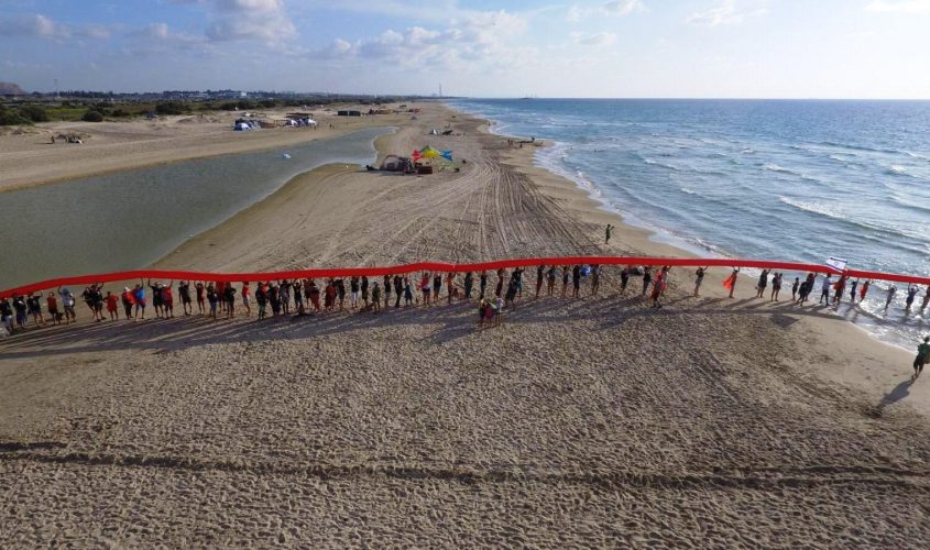 מיצג מחאה "הקו האדום" בחוף מעין צבי. צילום: דורון גזית